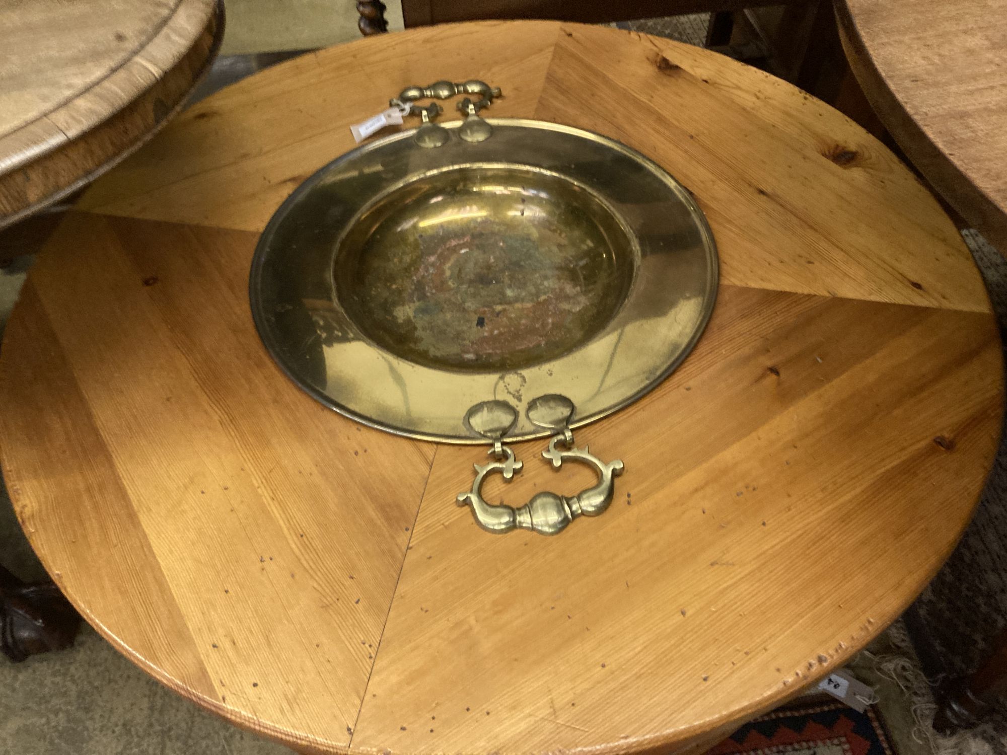 A circular pine low table inset two-handled brass brazier, diameter 108cm height 43cm